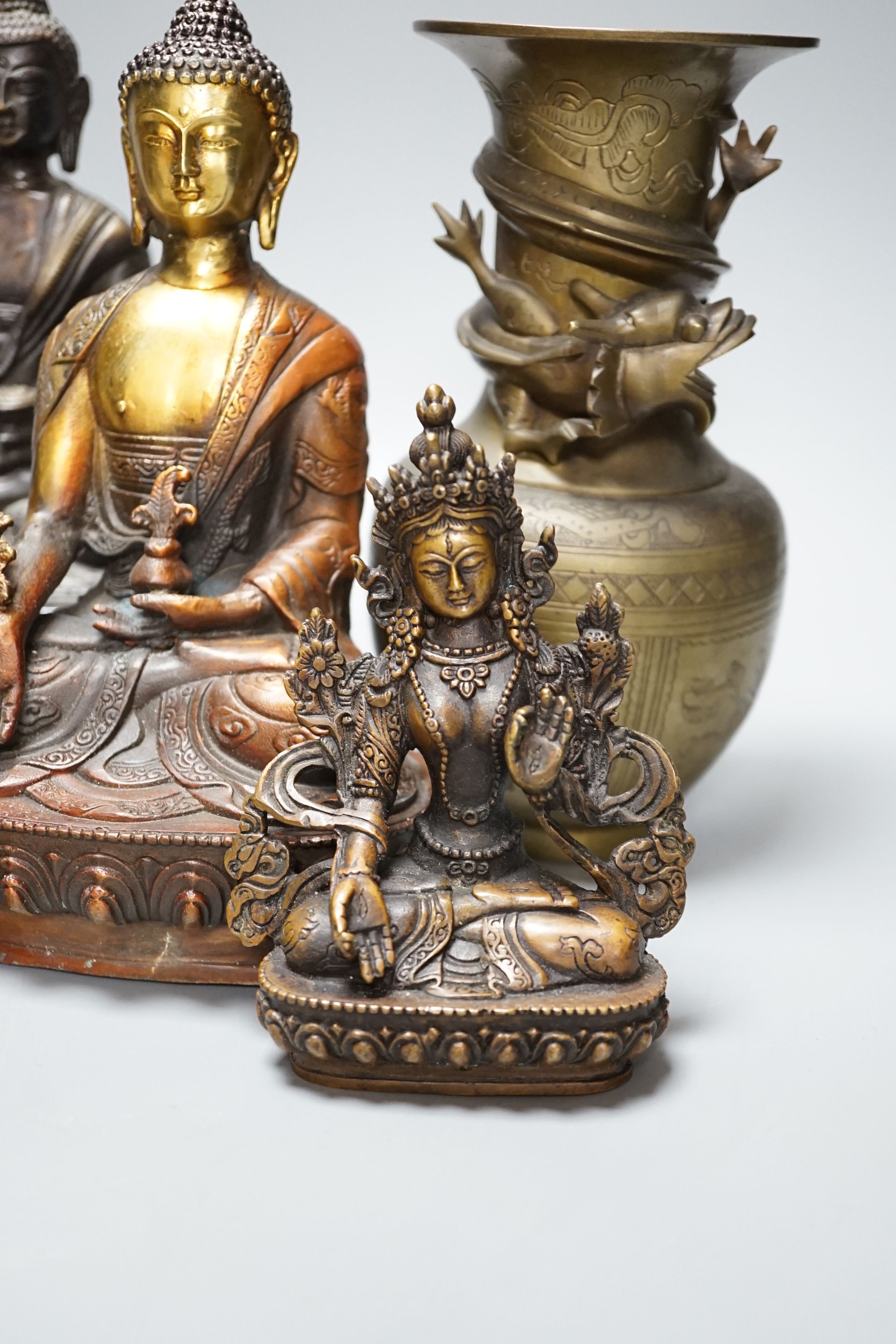 A group of five Tibetan or buddhist bronzes of deities and a Chinese bronze ‘dragon’ vase, tallest 21cm